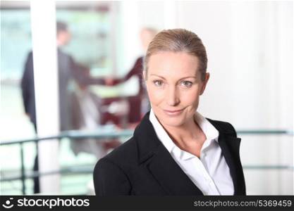 Blonde woman in front of rail