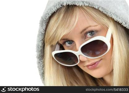 Blonde woman in large white sunglasses and a hooded fleece