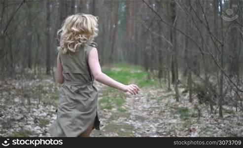 blonde woman in the forest running