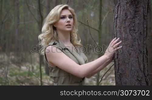 blonde woman in the forest running escaping