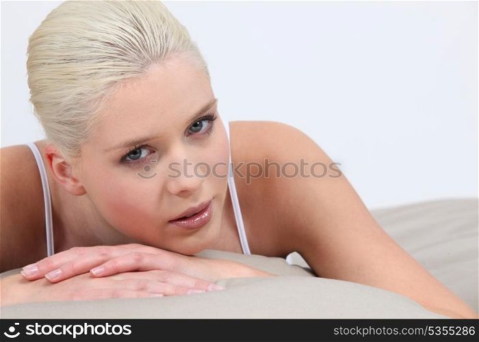 Blonde woman lying in bed