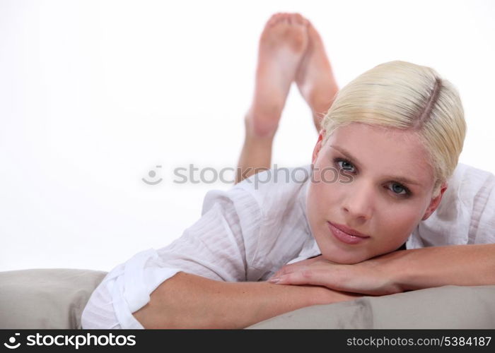 Blonde woman lying in bed