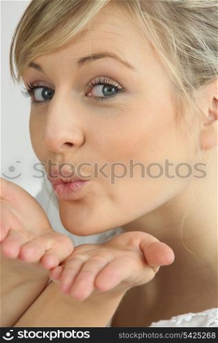 Blonde woman pulling air kiss