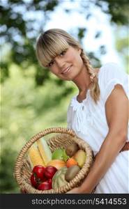 blonde woman showing a fruits basket