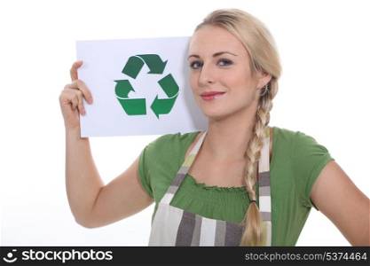 blonde woman showing the recycling symbol