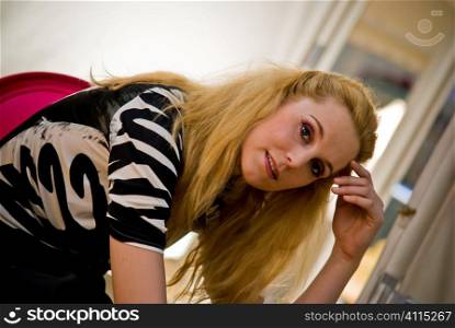 Blonde woman sits looking at camera