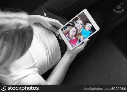 Blonde Woman Sitting On A Sofa Using Her Tablet