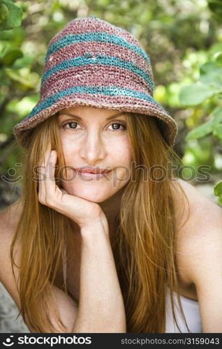 Blonde woman smiling, wearing stripped hat