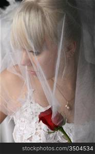 Blonde woman wearing a veil and white dress