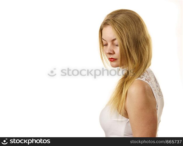 Blonde woman wearing white top with laced detail on cleavage. Fashion, clothing style concept.. Woman wearing white laced top