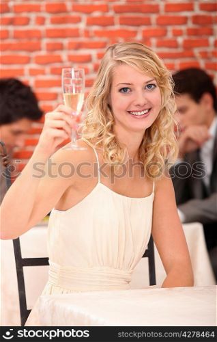 Blonde woman with a glass of white wine