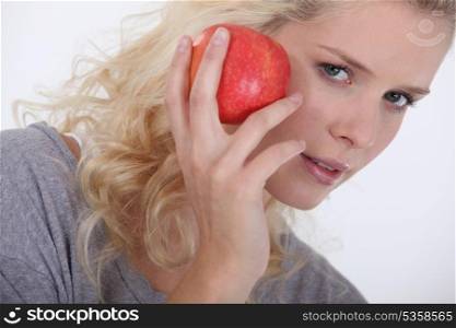 Blonde woman with an apple