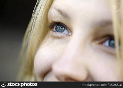 Blonde woman with blue smiling eyes