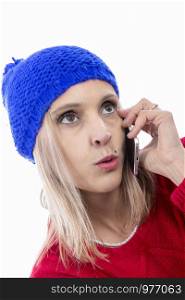 blonde woman with blue winter hat talking on the phone