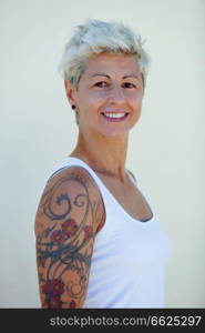 Blonde woman with flowered tattoos on her arm 