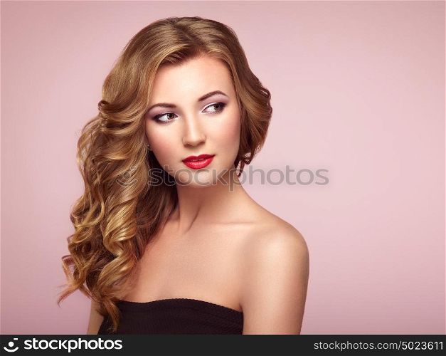 Blonde woman with long and volume shiny wavy hair . Beautiful model with curly hairstyle. Perfect make-up. Beauty style model