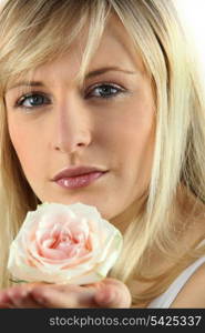 Blonde woman with rose in hand