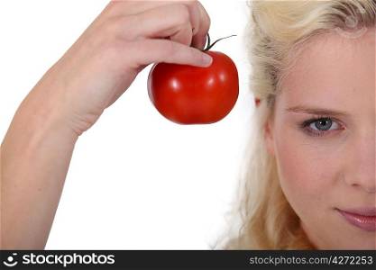 Blonde woman with tomato