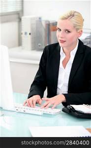 Blonde woman working at her computer