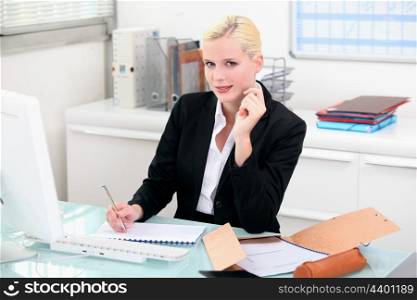 Blonde woman working at her desk