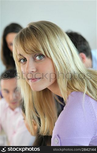 Blonde woman working with colleagues