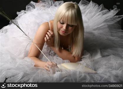 Blonde woman writing in a book
