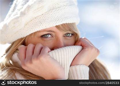 blonde wrapped in pullover by cold weather
