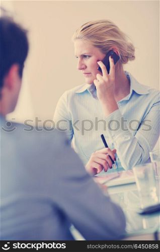 blonde young business woman talk by cellphone on meetng