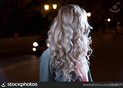 Blonde young girl, waves of the hairs, backside view, no face