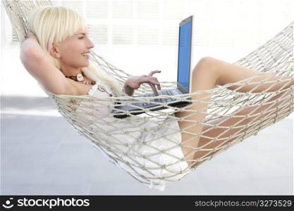 blonde young student fashion girl laptop hammock