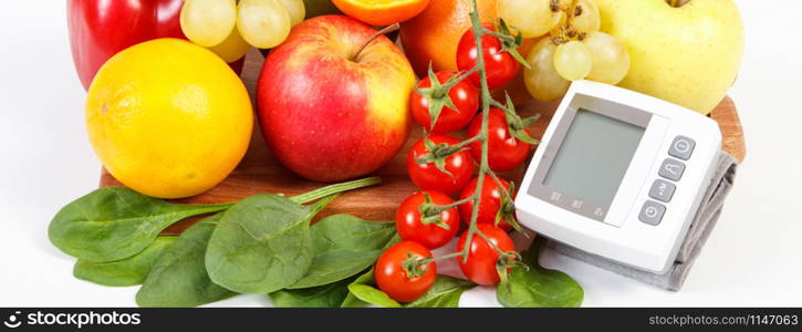 Blood pressure monitor and fresh fruits with vegetables, healthy lifestyle and prevention of hypertension concept. Blood pressure monitor and fruits with vegetables, healthy lifestyle