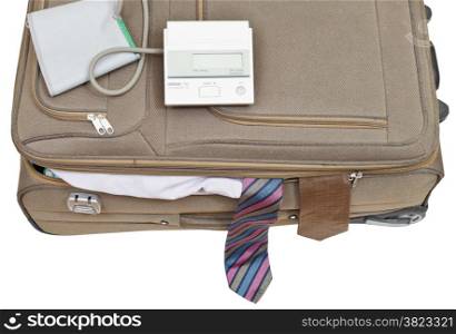 blood pressure monitor on suitcase with male ties isolated on white background