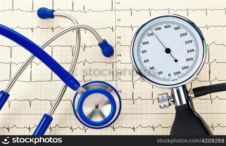 blood pressure monitor, stethoscope and ekg curve. correct blood pressure measurement.