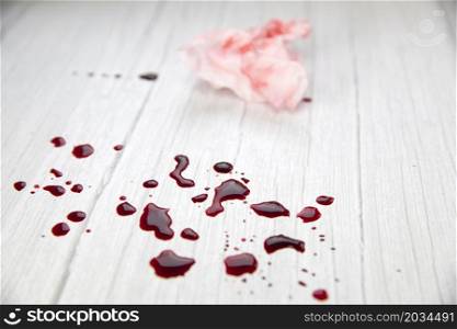 blood stains on white wooden background, dripped and splatterd blood with copy space, injury wound, concept space for text. blood stains on white wooden background, dripped and splatterd blood with copy space, injury wound, concept