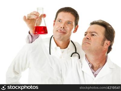 Bloodthirsty doctor licks his lips as a colleague analyzes a blood sample. Humorous image.