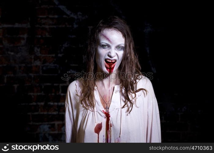 Bloody and scary looking zombie woman