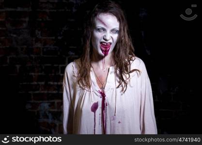 Bloody and scary looking zombie woman