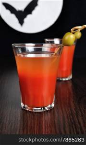 Bloody Mary cocktail with olives on a background of the moon