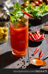 Bloody mary cocktail with pepper and hot snacks on dark board.hard light.