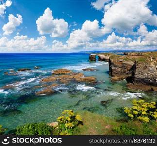 Blossoming Cantabric coast summer landscape with blue picturesque sky (Cathedrals Beach, Lugo, Galicia, Spain).