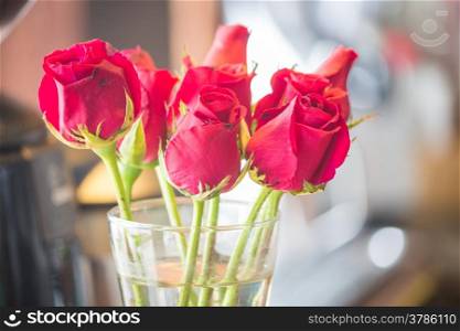 Blossoming red roses in vase, stock photo