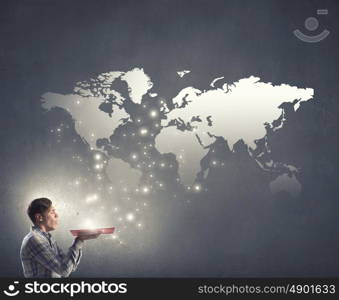 Blow dust from pages. Young businessman with opened book in hands blowing on pages