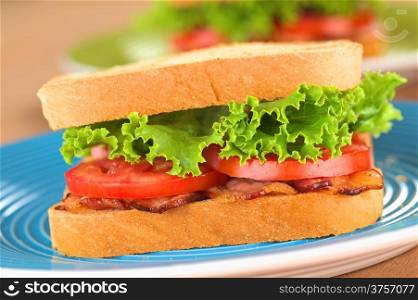 BLT (bacon, tomato, lettuce) wholewheat sandwich (Selective Focus, Focus on the front of the first sandwich)