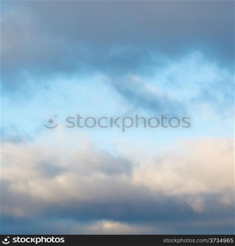 blue afternoon sky in break of grey winter clouds