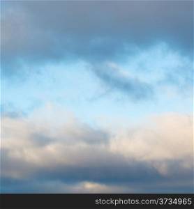 blue afternoon sky in break of grey winter clouds