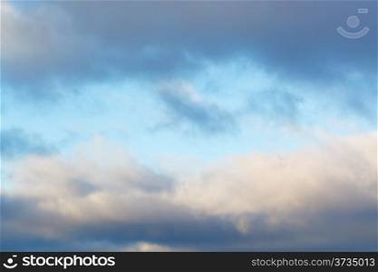 blue afternoon sky in break of harsh winter clouds