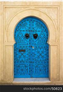 Blue aged door with ornament from Sidi Bou Said in Tunisia