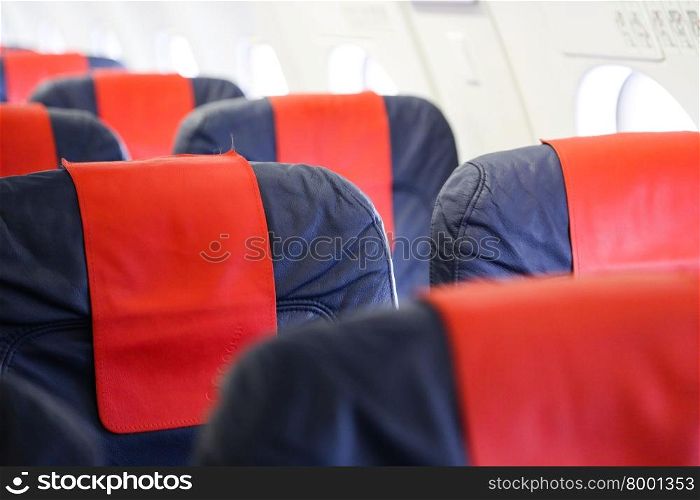 Blue airplane seats in an airplane cabin