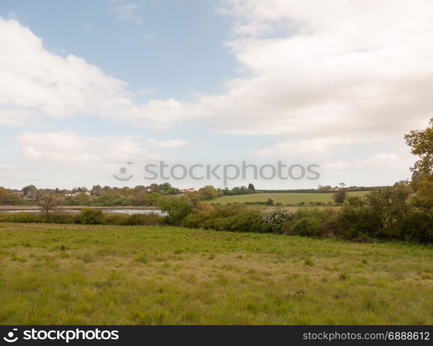 blue and cloudy countryside scene outside in an open field