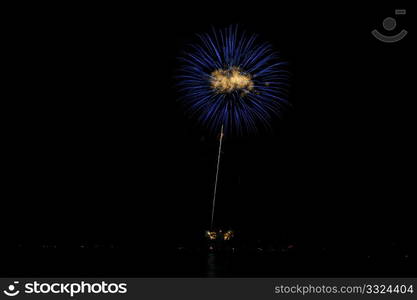 Blue And Gold Fireworks. Colorful nighttime fireworks against a solid black sky over Lake Tahoe on the fourth of July holiday 2010